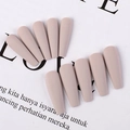 Macro detail of matte nude pink long coffin press on nails in a professional arrangement - Khaki