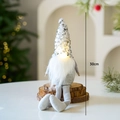 Light-up Christmas gnome with silver sequins and long legs sitting on wood, 30cm height - Silver Long Leg Gnome B