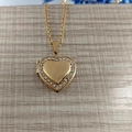 Golden heart locket necklace with sparkling white rhinestones on a cross chain - Rhinestone Style with Chain / Gold