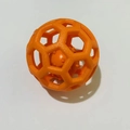 Orange hollow TPR rubber dog toy ball with internal squeaker and hexagonal cutouts - Orange Ball-in-Ball (Orange Core)