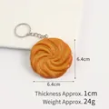 Realistic PVC cookie keychain showing 6.4cm x 6.4cm dimensions and baking texture - Yellow Spiral Cookie Keychain