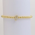 Detail shot of golden beaded bracelet with shimmering zircon-paved letter P charm - Letter P