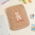Detail of khaki quilted laptop sleeve featuring lucky bear plush embroidery and padding - 11" / Brown Bear