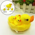 Yellow rubber duck bath toy set with one large and three small ducks in white mesh bag - Mother and Baby Duck Set