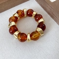 Bracciale retrò con perline di ambra acrilica e distanziali in metallo dorato - Caffè-Oro