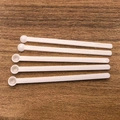 Set of five long-handled white plastic measuring spoons on a wooden background - 0.025ml Long Handle (7*0.6*0.3cm) / White