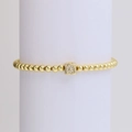 Golden beaded stretch bracelet featuring a cubic pendant with sparkling letter Q or C - Letter Q