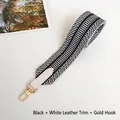 Detail of wide black and white geometric woven strap with white leather and gold hooks - Black with White Trim