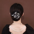 Elegant black and white rose hair bun clip with small butterfly detail on model - Peony Grey
