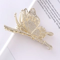 Detailed view of a golden butterfly hair claw clip with sparkly rhinestones and metal finish - Rhinestone Butterfly