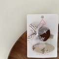 Detail of fabric hair clips with polka dots, lace and floral patterns on card - Little Rabbit
