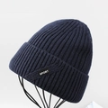 Detail of navy knit beanie with sport tag showing ribbed texture and warm fleece lining - Navy Blue