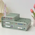 Close-up of a mint green desk organizer with drawers and cute cartoon stickers - Three Drawers with Stickers / Green