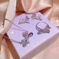 Bow necklace, ring and earrings set with pink heart-shaped stones on beige silk - Pink 3-Piece Set