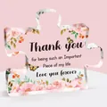 Detail of puzzle-shaped acrylic plaque with floral prints and Thank You message - General Thanks Style (Q18)