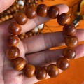 Close-up of polished red cedar barrel beads showing natural wood grain and texture - Thuja Aged Wood Beads 13/14mm