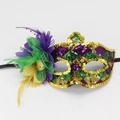 Macro detail of Mardi Gras mask with purple green gold sequins and feather flower - Style 10