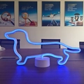 Blue LED neon dachshund light with white base, glowing on desk for modern home decor - 2023 New Dachshund
