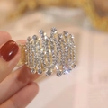 Detailed close-up of a golden ponytail clip set with sparkling rhinestones and wave patterns - Crown Gold Rhinestone Claw