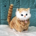 Lifelike orange tabby cat plush toy with blue eyes and pink flower pendant on white base - Orange Chubby Cat With Sound