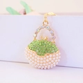 Golden handbag keychain with white pearls, green rhinestones and a metallic chain - Green