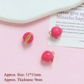 Detailed close-up of 11mm mini pink strawberry pendants with gold leaf hooks - Lychee