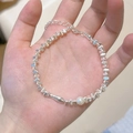 Detail showing silver beaded bracelet with a white pearl and abstract small fish charm - Silver Square Pearl Small Fish (MY30972)
