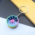 Detail of neo chrome metal car wheel rim keychain with multi-spoke design on wooden block - 37MM Wheel Rim / AB Color