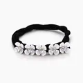 Elastic black hair tie featuring five white resin flowers with sparkling rhinestones - Shell Flower