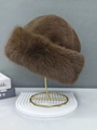 Detailed close-up of dark brown faux fur bucket hat texture on a golden stand - One Size / Brown