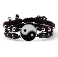 Close-up of Yin Yang Tai Chi bracelets with woven cords and metallic beads on white background - Tai Chi Coffee Pair