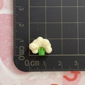 Miniature resin broccoli food model with green stem on a black cutting mat showing 1.5cm size - Cauliflower