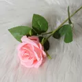 Realistic light pink velvet artificial rose flower on soft white plush fabric background - Coral Pink