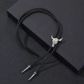 Vintage western bolo tie featuring a silver bull head pendant and black braided leather cord - One Size / Antique Silver Bull Skull