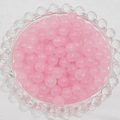 Detail of translucent pink glass beads in a textured glass bowl for DIY jewelry making - 4mm / Pink