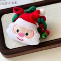 Detail eines Plüsch-Weihnachtsmann-Haargummis mit rot-grünem Seil und kleinen Glöckchen - Weihnachtsmann
