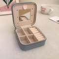Detail view of small blue PU leather jewelry box with mirror and ring slots - Gray