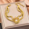 Macro shot of double-layer snake chain bracelet with golden flower and pearl on silk - Pearl Hollow Flower