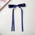 Detailed view of a navy blue silk ribbon bow hair clip on a clean white background - Navy Blue