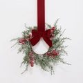 Detail of Christmas wreath with cedar leaves, red berries and velvet ribbon bow - Snow 7 Fruit Cluster Pine Cypress Red Velvet Bow