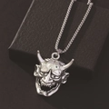 Silver Japanese Hannya mask pendant with ball chain on a black textured background - Antique Silver