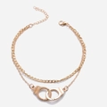 Dubbellaagse gouden ketting met handboeien hangers en FREEDOM gravure - Goud