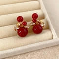 Macro shot of 18K gold-plated cluster stud earrings with red beads and zircon accents - Round Flower Style