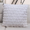 Close-up of light grey plush pillow case with embossed heart pattern on striped sofa - Light Gray
