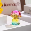 Macro detail of a colorful gradient crystal dog figurine in a warm home setting - Zodiac Dog / Rainbow Gradient