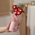 Detailed view of hand-knitted red puff flower bouquet in pink paper hug bucket gift - With Light + Bag / Red Small Flower