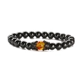Detailed macro view of black glossy beads and amber-like bead with crown metal caps - Crown + Hematite