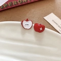 Close-up of apple stud earrings featuring red enamel finish and small diamond details - Red Apple Earrings