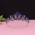 Macro view of baroque gold crown featuring deep blue rhinestones and filigree detail - No.2 KC Gold (Royal Blue Stone)