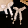 Detail of Christmas bow earrings with white fur, zircon snowflakes and pearl drops - White Plush Bow Pearl Rhinestone Earrings